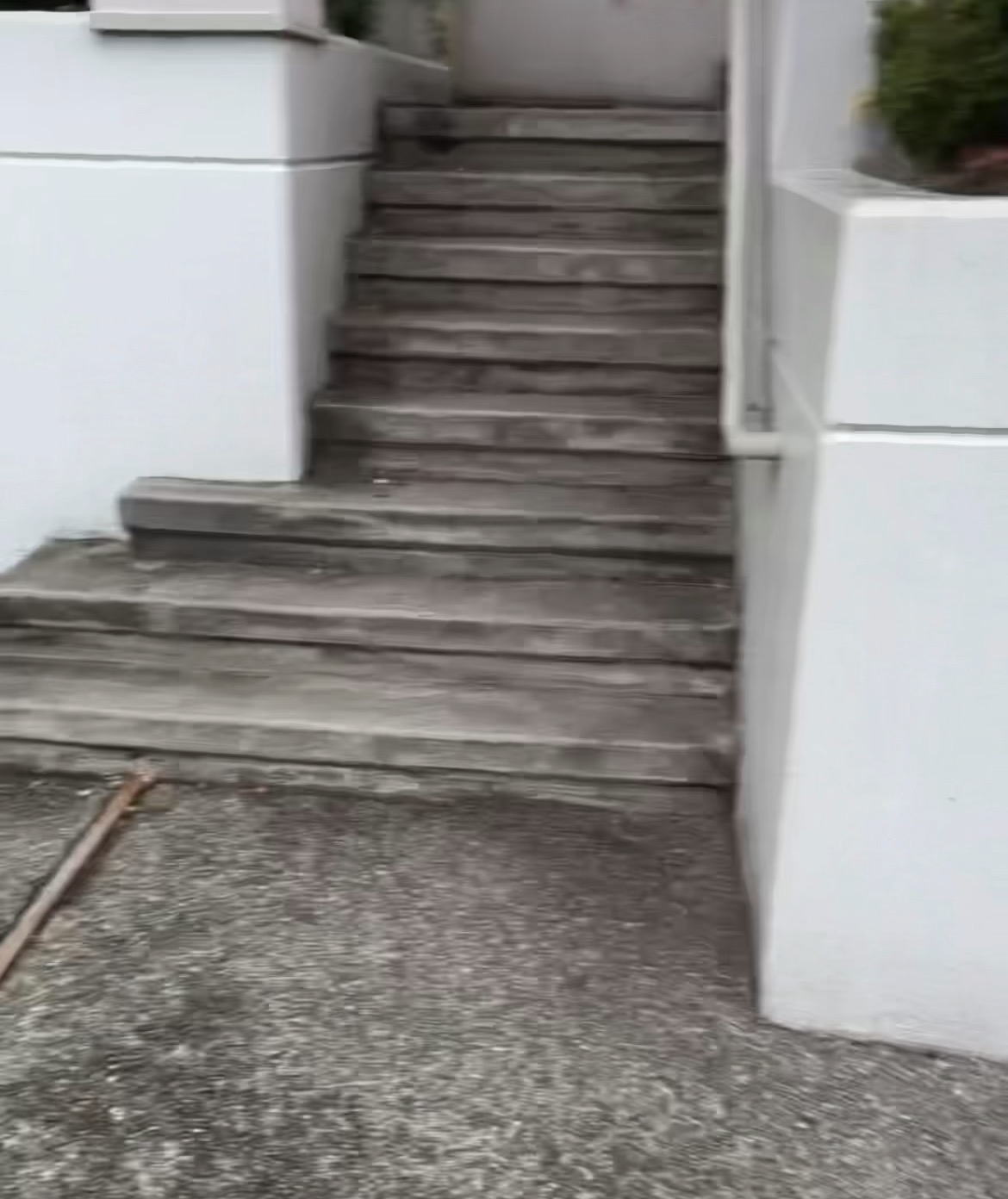 Dirty concrete walkway and steps before pressure washing